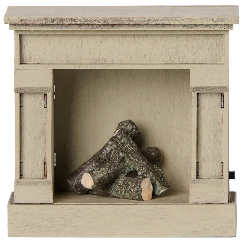 A compact, off white wooden fireplace model by Maileg, featuring decorative logs inside, perfect for adding a vintage touch to your miniature home.
