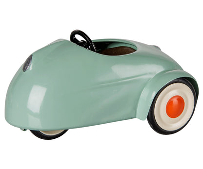 A Light Mint Car - Mouse by Maileg, featuring a minimalist design in mint green metal with white wheels and orange hubcaps, is displayed on a white background.