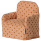The Maileg Folding Chair, Mouse - Dots, is a small upholstered chair with orange polka dots on light orange fabric, perfect for the Mouse hole Farmhouse or as a cozy seat for your little Maileg friends, shown isolated on a white background.