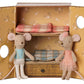 Two Ballet Mice in Dance Studio—Little Sister and Brother by Maileg stand before a yellow wardrobe adorned with floral patterns, revealing two bunk beds with plaid blankets and creating a charming scene in their mouse house.