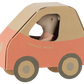 A Maileg Driver Mouse, Little Sister sits inside a charming car with red sides and large round wheels.
