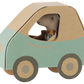 A Maileg Driver Mouse, Little Brother sits inside a blue and brown cardboard mouse car with round wheels.