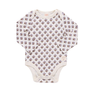 The Coop Kids PC Baby Girls’ Baby Wonder Bodysuit features long sleeves and a beige background adorned with a delicate purple floral pattern. Designed for easy changes, this bodysuit is displayed flat against a white backdrop.