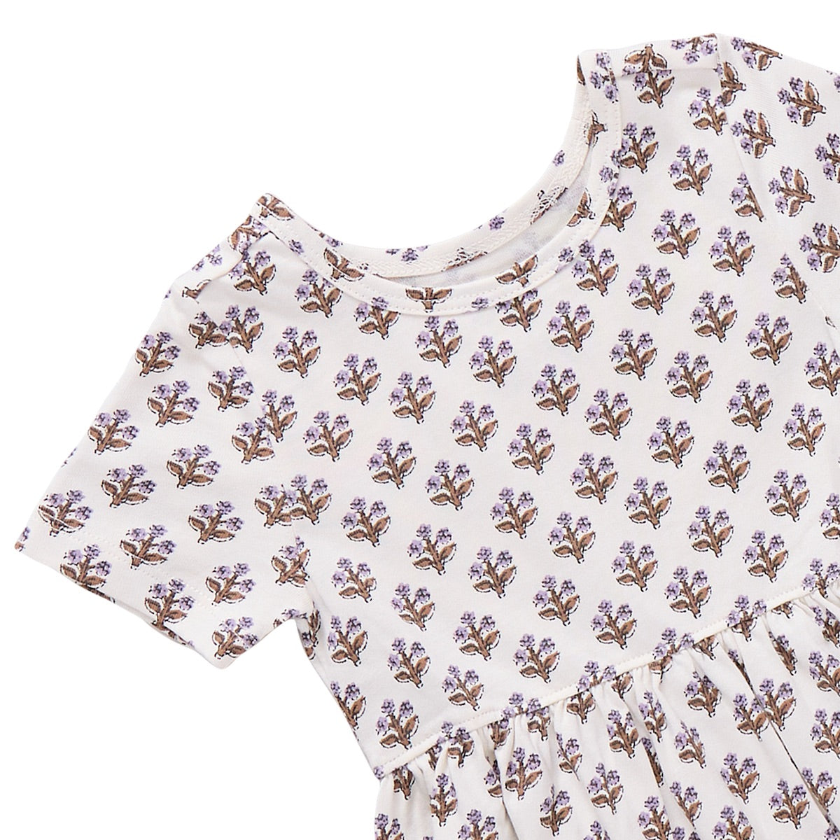 Girls’ Sunny Dress by Coop Kids PC: A short-sleeve cream dress with a round neckline, adorned with an all-over small purple and brown floral print. Made from organic Pima cotton, this versatile piece delivers comfort and easy style for any occasion.