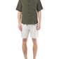 A person in a customized dark green short-sleeve button-up shirt and Onia's Air Linen Pull-On Short stands barefoot against a plain white background.