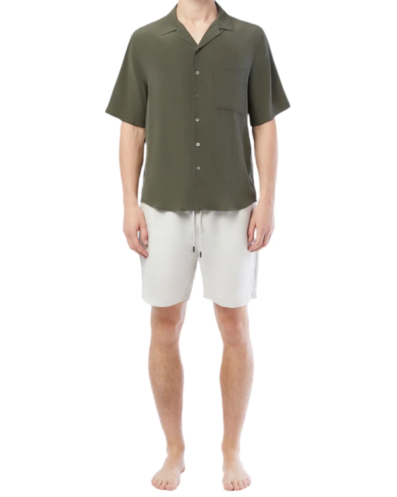 A person in a customized dark green short-sleeve button-up shirt and Onia's Air Linen Pull-On Short stands barefoot against a plain white background.