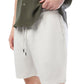 A person in a green shirt and Onia's Air Linen Pull-On Short in white, made from a linen-tencel blend, casually holds the shirt hem with their left hand.
