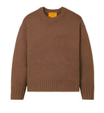 The Guest in Residence Cozy Crew Cashmere Sweater, in a brown knit with ribbed neck trim, cuffs, and hem, showcases a chic dropped shoulder design and is displayed on a white background.