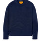 The Guest in Residence Cozy Crew Cashmere Sweater in dark blue showcases a cozy design with a round neckline, along with ribbed hem and cuffs. A gold label can be found on the inside collar.