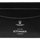 The Capra Flat Credit Card Case by Ettinger, crafted from black goat leather, is embossed with the "Ettinger London" and crest logo in white. This minimalist design has two card slots and one central slot, ideal for a credit card holder.