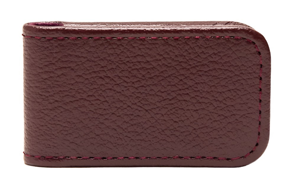 The Ettinger Capra Magnetic Cash Clip, crafted from luxurious brown goat leather and accented with red stitching, combines elegance with functionality. Featuring a sleek magnetic cash clip, it keeps your essentials securely stylish.