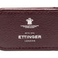 The Capra Magnetic Cash Clip is crafted from luxurious burgundy goat leather, featuring the Ettinger logo embossed in white with the establishment year, 1934.