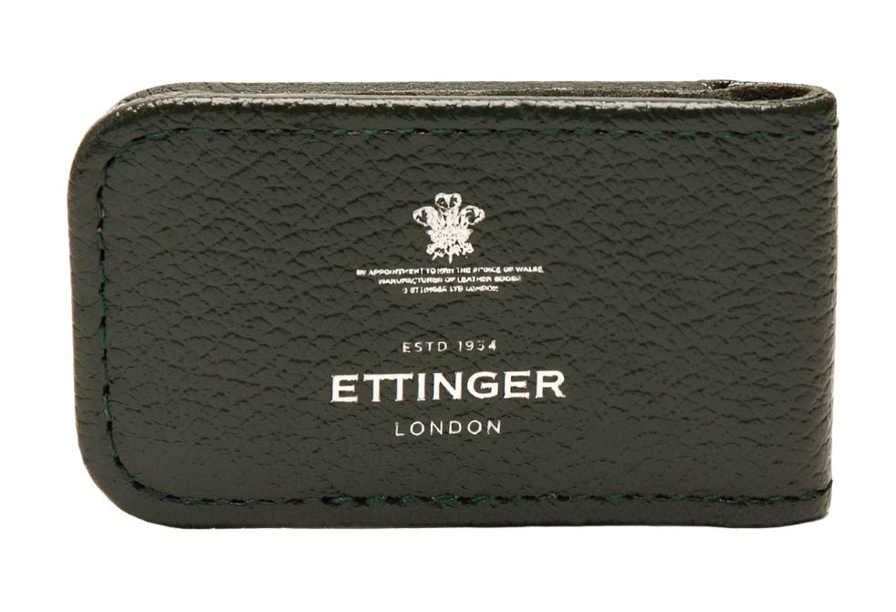 The Ettinger Capra Magnetic Cash Clip, crafted from luxurious green goat leather, features an embossed Ettinger logo and the text "ESTD 1934," blending elegance and function in a stylish magnetic money clip.