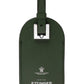 The Capra Luggage Tag with Security Flap by Ettinger is an elegant green tag crafted from premium goat leather, featuring a silver buckle and embossed with "Ettinger London" alongside a crest.