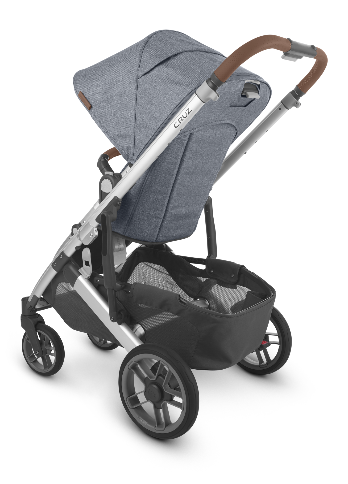 A side view of the UPPAbaby Cruz V2 Stroller by UPPAbaby, featuring a grey fabric toddler seat, a brown adjustable handlebar, and a silver frame. The stroller includes a storage basket underneath and four black wheels.