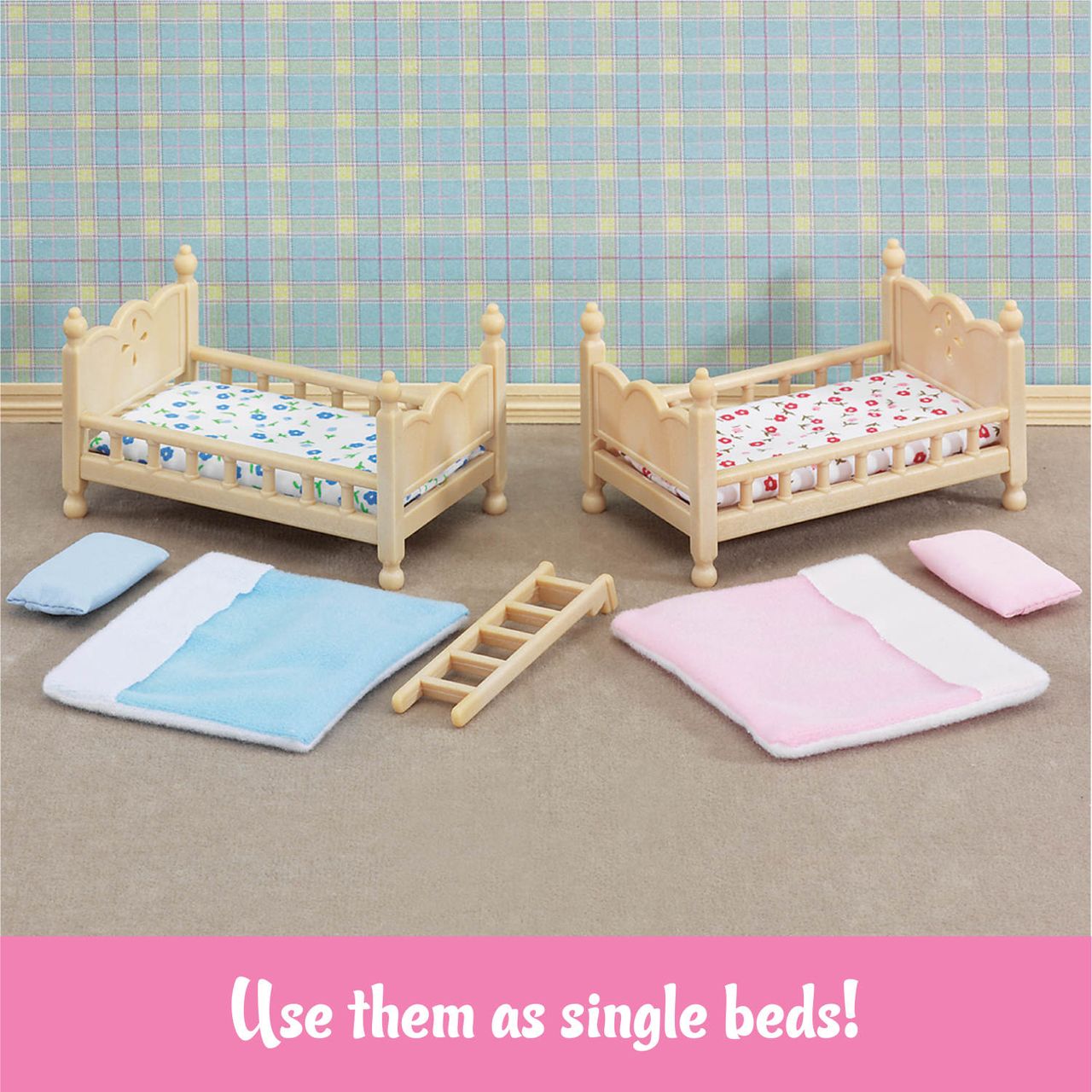 Two small wooden Calico Critters Stack and Play Beds with patterned bedding, a ladder, blue and pink bedding sets, plus pillows are arranged on a carpeted floor against a plaid wallpaper backdrop—perfect as dollhouse furniture.
