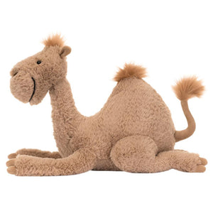 Introducing the Jellycat Richie Dromedary by Jellycat: a cute and cuddly plush camel toy featuring a single squishable hump, with its legs neatly folded underneath. This light brown toy is complete with a fluffy tail and ears.