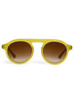 The Cameron Sunglasses by Krewe feature yellow acetate frames, round brown gradient lenses, and a subtle brow bar, displayed from the front on a white background.