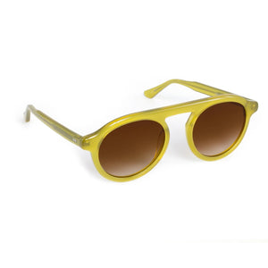 The Krewe Cameron Sunglasses feature yellow acetate round frames, a subtle brow bar, and brown gradient lenses, displayed at an angle on a white background.