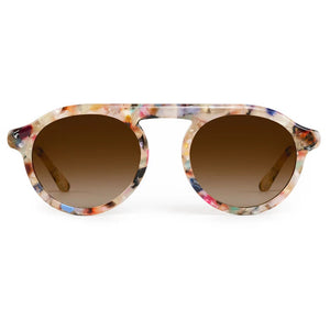 The Cameron Sunglasses by Krewe feature round brown gradient lenses and a colorful speckled acetate frame, displayed against a white background.