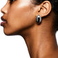 Profile of a person wearing the eye-catching LIÉ STUDIO Camille Earrings, crafted from 925 sterling silver and featuring black accents, against a white background.