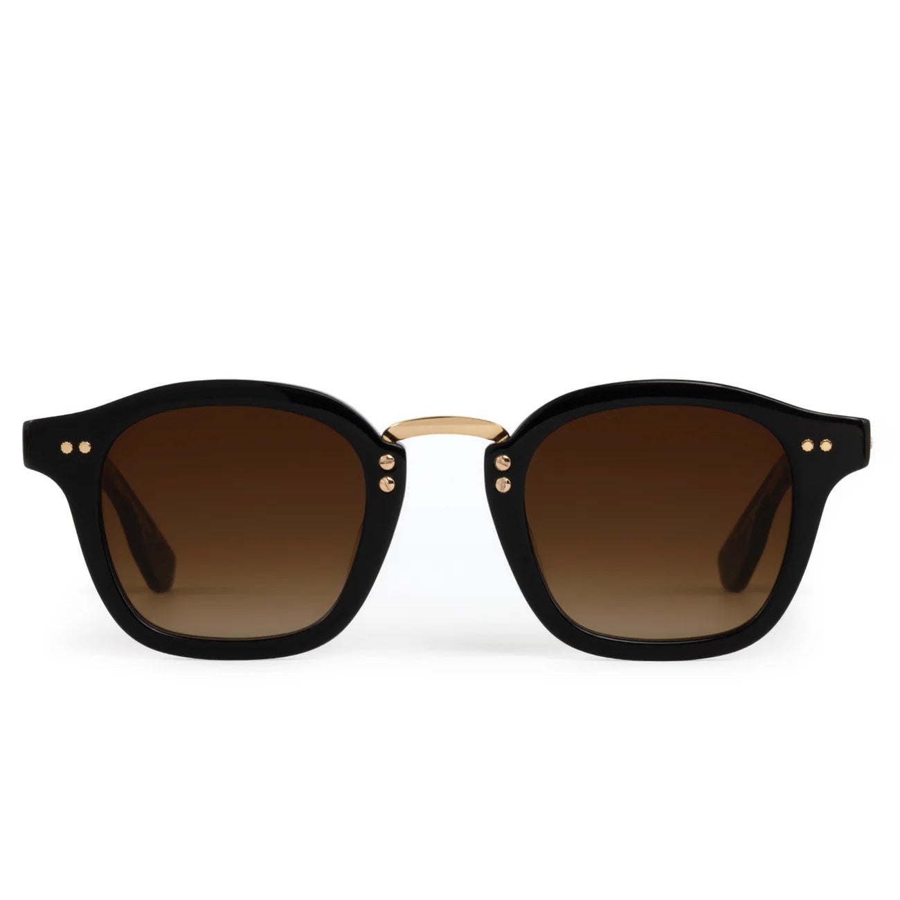 The Krewe Campbell Sunglasses have black square acetate frames, brown gradient lenses, and a gold bridge with precious metal accents, shown against a white background.