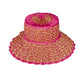 The Island Capri Hat by Lorna Murray features a wide brim and a pink, yellow, and white woven pattern with a solid pink top and brim edge. Offering UPF 50+ protection, this travel-ready hat is displayed on a white background.