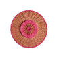 Round decorative pillow with layered pink and multicolored fabric, featuring a textured and gathered design with a central button accent—perfect for adding a playful pop of color to your space or complementing your favorite Lorna Murray Island Capri Hat during travel, viewed from above on a white background.