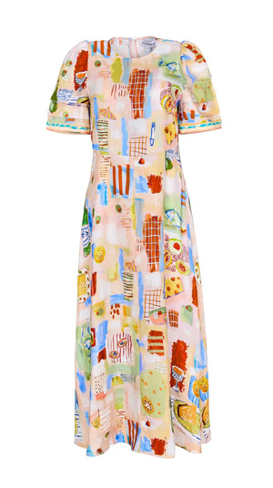 The Casey Dress by Hunter Bell NYC is a knee-length sheath midi with short puff sleeves, showcasing a colorful abstract geometric and food-themed pattern on a light background.