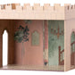 The Maileg Castle Hall by Maileg is a cardboard model showcasing painted walls adorned with floral and chandelier designs, arched doorways, and tiled flooring. It features an open top and one missing wall to provide a captivating interior view. This enchanting playset is recommended for children aged 3 and up, perfect for sparking palace adventures.