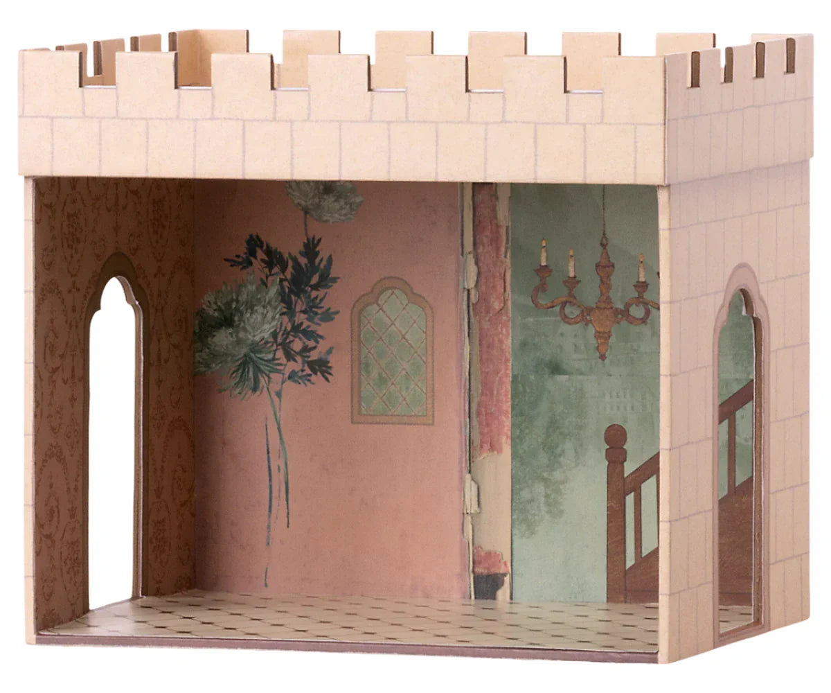 The Maileg Castle Hall by Maileg is a cardboard model showcasing painted walls adorned with floral and chandelier designs, arched doorways, and tiled flooring. It features an open top and one missing wall to provide a captivating interior view. This enchanting playset is recommended for children aged 3 and up, perfect for sparking palace adventures.