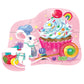 Featuring a mouse chef with a cupcake surrounded by candy and fruit, the Crocodile Creek's "Celebration! 12 Piece Mini Puzzle" offers a playful pink background. Ideal for beginners, some pieces are whimsically missing, adding fun to any party.