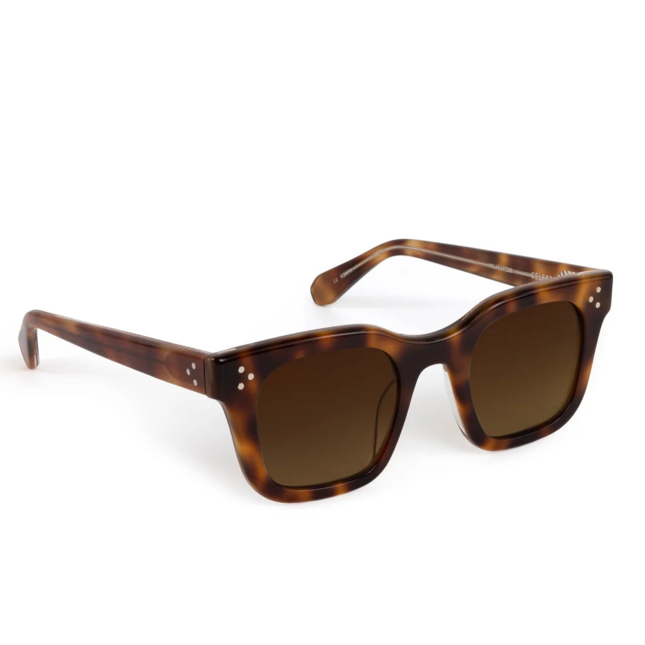 The Krewe Celeste Polarized Sunglasses feature square tortoiseshell frames, brown-tinted lenses, thick temples, and subtle silver dot accents on the front corners for a classic handcrafted look.