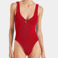 A person wearing the Hunza G Celine Tonal Hoop Swim, a red one-piece with crinkle fabric and a front keyhole cutout, photographed against a plain background.
