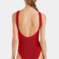 A woman with a braid models the Hunza G Celine Tonal Hoop Swim, a red, sleeveless, low-back one-piece swimsuit, shown from behind against a plain background.