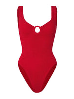 The Celine Tonal Hoop Swim by Hunza G is a red one-piece with wide straps, a scoop neckline, and a front circular cutout, crafted from crinkle fabric for a flattering fit.