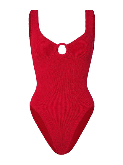 The Celine Tonal Hoop Swim by Hunza G is a red one-piece with wide straps, a scoop neckline, and a front circular cutout, crafted from crinkle fabric for a flattering fit.