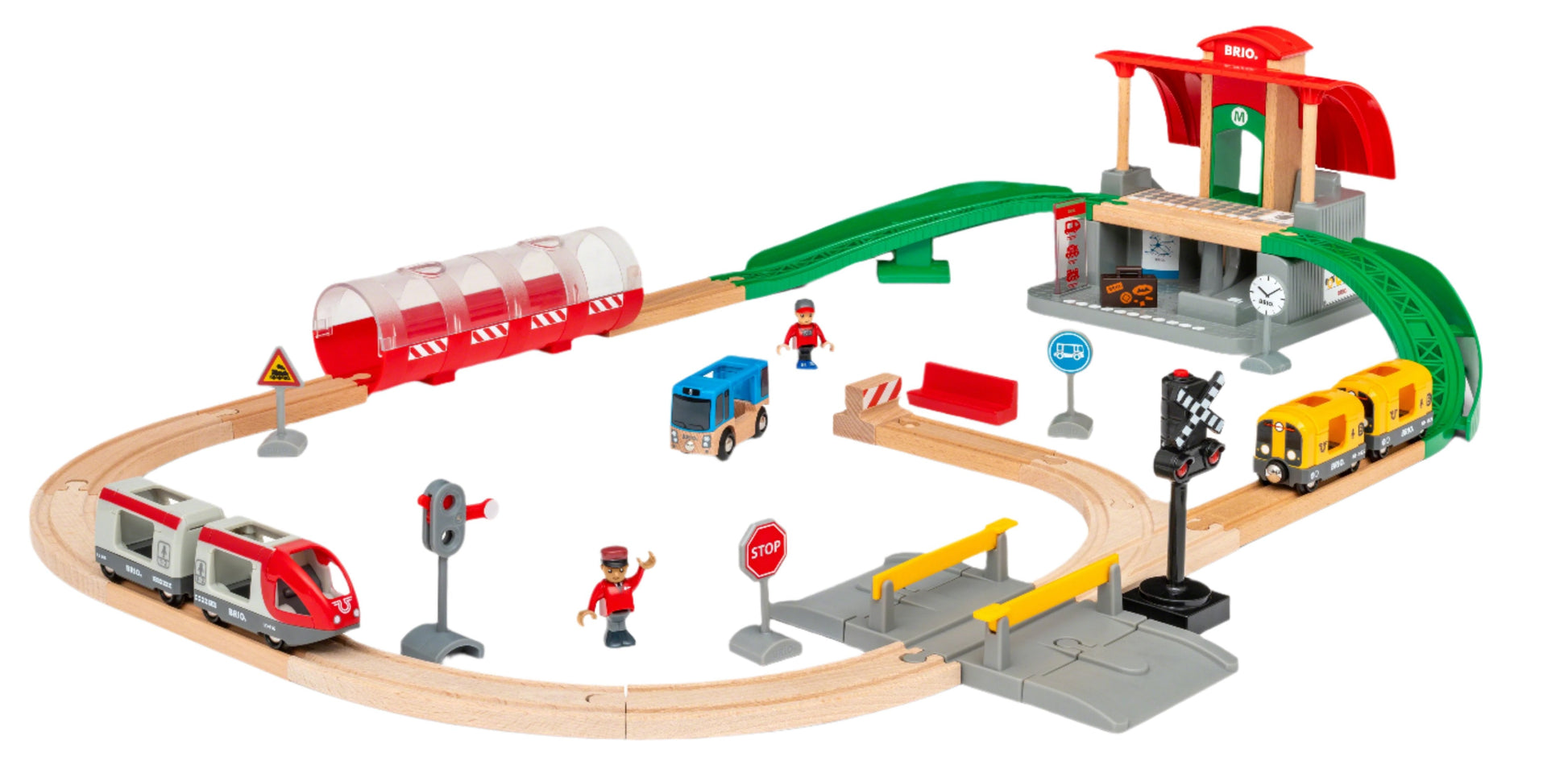 The BRIO World Train Set Central Station Set by Brio includes wooden tracks and plastic trains, along with a station, bridge, and various railway accessories like figures, signs, and a crossing gate.