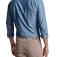 A man is standing with his back to the camera, wearing a Peter Millar Japanese Selvedge Sport Shirt and beige pants.