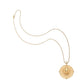 The Jane Win Destination Pendant Necklace Collection features a gold coin pendant with a round sunburst design and central raised motif, shown on a white background—ideal for fans of unique necklaces.