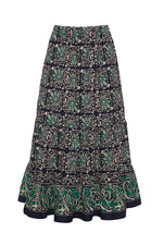 The Cara Cara Chase Skirt by Cara Cara is a patterned cotton poplin skirt featuring a paisley design in navy, green, and cream. It has an elastic waistband for comfort, elegant tiers, and a ruffled hem.