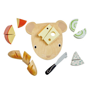 Tender Leaf Toys' Tender Leaf Cheese Chopping Board features a wooden cheese board, a mousey cheese knife, bread, velcro-backed cheese for easy cutting, apple slices, and cucumber slices, all presented on a white background.