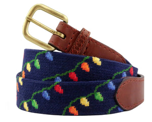 The Christmas Lights Belt by Smathers & Branson features a navy needlepoint design with hand-stitched multicolored string lights, Italian leather accents, and a brass buckle.