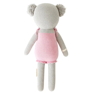Claire the Koala - Little 13" by Cuddle + Kind features a gray knit body, round ears, and a pink dress. Shown from the back, she’s ready for magical treetop adventures or cozy treehouse days.
