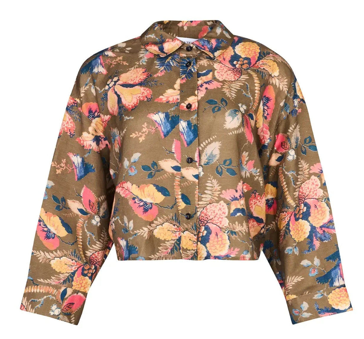The Clarke Shirt by Hunter Bell NYC is a brown oversized cropped shirt with a colorful floral pattern in pink, yellow, navy, and cream. It features long sleeves, a collar, and a modern boxy fit.