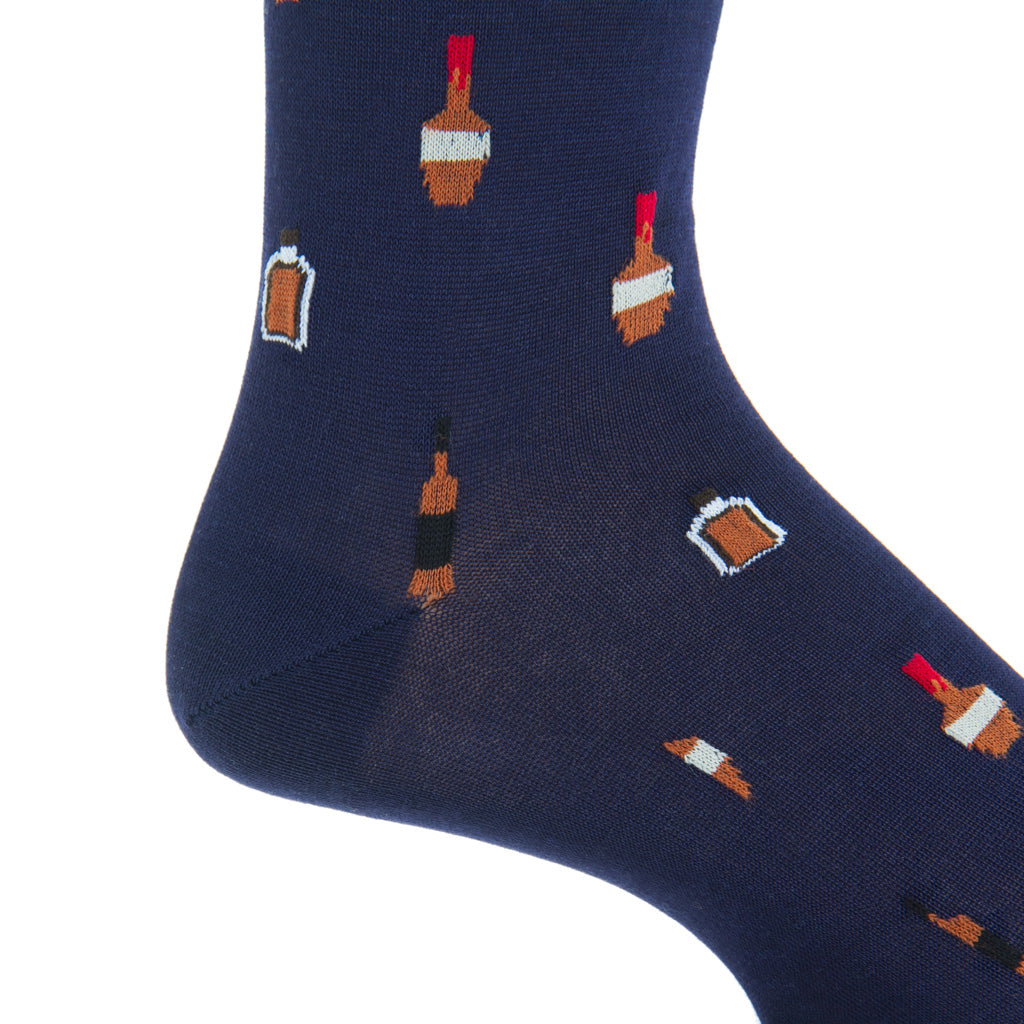 Close-up of the Dapper Classics Bourbon Bottle Mid Calf Socks in Classic Navy and Burnt Orange, showcasing a pattern of small, colorful bottle designs crafted from luxurious mercerized cotton.