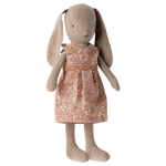 The Maileg Bunny Size 1, Classic - Flower Dress, is a beige stuffed toy bunny crafted from soft natural fabrics and dressed in a charming pink floral dress.