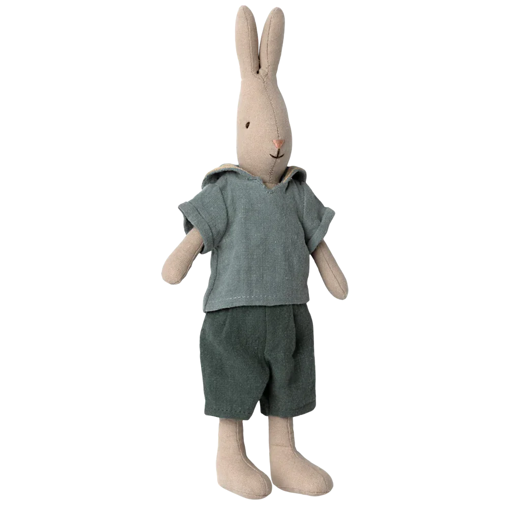 The Maileg Rabbit Size 2, Classic - Shirt and Shorts from the renowned Maileg brand is dressed in a charming green shirt and shorts, adding a delightful touch to the dollhouse collection.