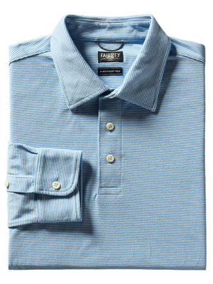 Folded blue striped button-up shirt with a collar and single cuff, showcasing the "Faherty" label inside. This Faherty Movement Long-Sleeve Pique Polo features a classic fit design with innovative fabric and a vented hem for enhanced comfort and style.