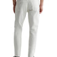 A person wearing AG Jeans Everett Sueded in white, a black shirt, and black shoes is shown from the back against a plain background. The sueded stretch sateen fabric of the jeans offers a comfortable mid-rise waist for ease of movement.